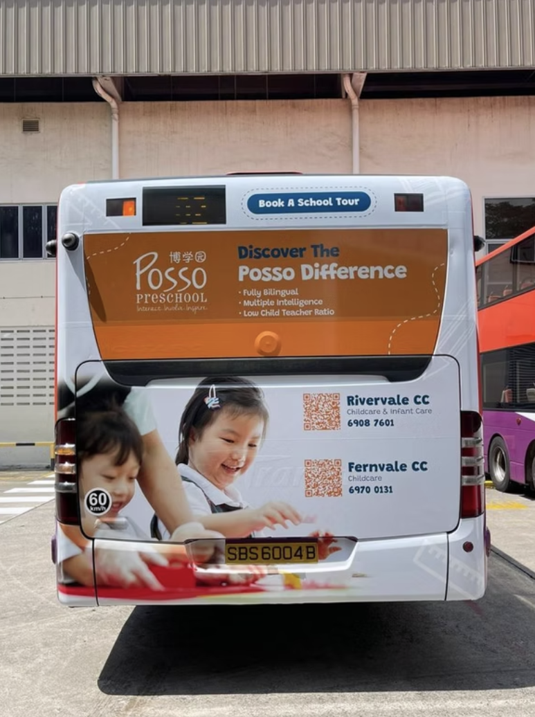 Rear of a bus featuring Posso Preschool branding and school-tour information